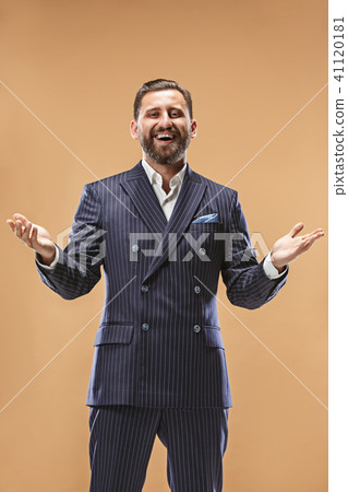 The happy business man standing and smiling against pastel background. 41120181