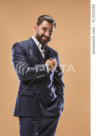 The happy business man standing and smiling against pastel background. 41120188