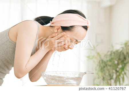 Washing face young Japanese lady rinse face 41120767