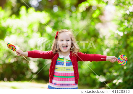 Little girl with colorful candy lollipop Little girl with colorful candy lollipop 41120853