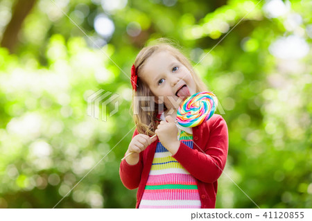 Little girl with colorful candy lollipop 41120855