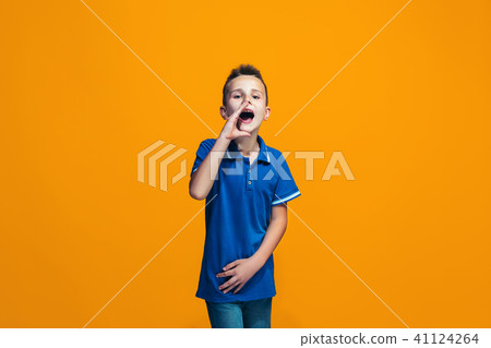 Isolated on orange young casual teen boy shouting at studio Isolated on orange young casual teen boy shouting at studio 41124264