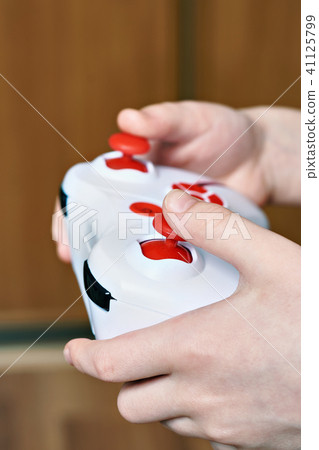 Child hands use remote control Child hands use remote control 41125799