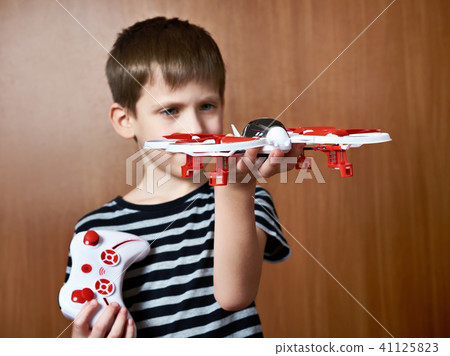 Little boy with toy quadcopter drone 41125823