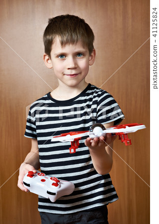 Little boy with toy quadcopter drone 41125824