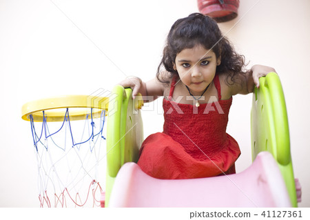 Girl with slide and basketball hoop Girl with slide and basketball hoop 41127361