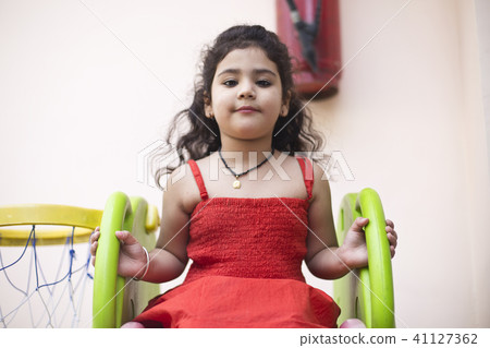 Girl with slide and basketball hoop Girl with slide and basketball hoop 41127362