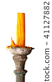Candle on ancient candle holder. 41127882