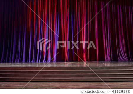 Red curtains and wooden stage. 41129188