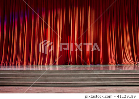 Red curtains and wooden stage. 41129189