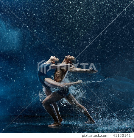 Young couple of ballet dancers dancing unde rwater drops Young couple of ballet dancers dancing unde rwater drops 41130141