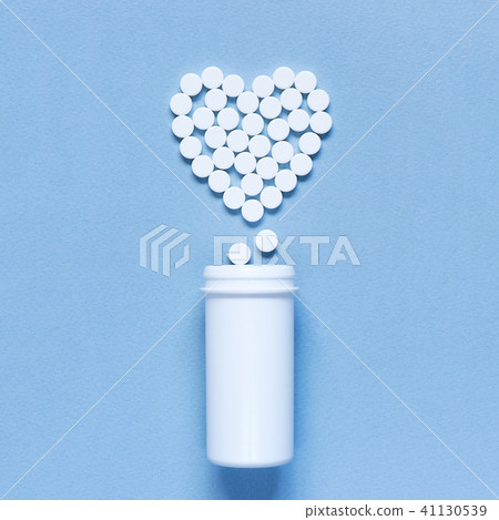 Heart made of pills on the blue background 41130539