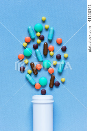 Colorful pills scattered from the container Colorful pills scattered from the container 41130541
