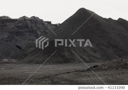 Coal mining at an open pit. Pile of black coal pieces Coal mining at an open pit. Pile of black coal pieces 41131090