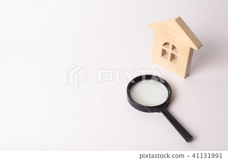 Wooden house and a magnifying glass 41131991
