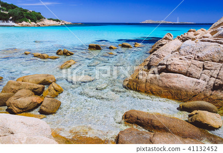Clear amazing azure and turquoise colored sea water with huge granite rocks in Capriccioli beach Clear amazing azure and turquoise colored sea water with huge granite rocks in Capriccioli beach 41132452