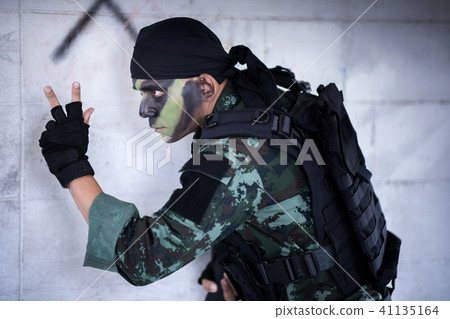 Asian army soldier send special signal to partner. Asian army soldier send special signal to partner. 41135164