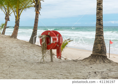 Red life buoy with rope and a flag Red life buoy with rope and a flag 41136197