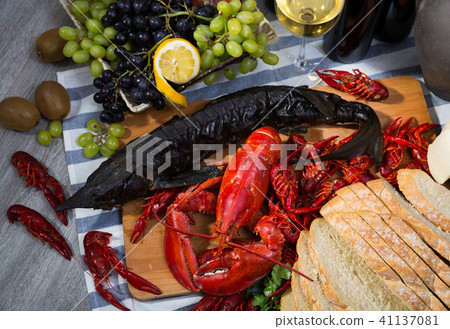Smoked sturgeon, seafoods and white wine, top view 41137081