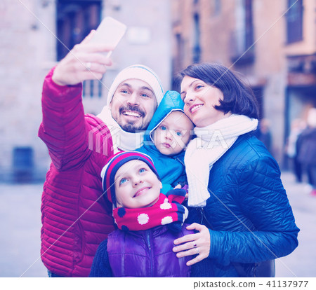 Family with children walking the city and doing selfie Family with children walking the city and doing selfie 41137977