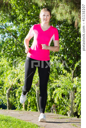 Female 20-30 years old is jogging in pink T-shirt 41138107