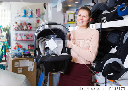 woman shows infant's car cradle woman shows infant's car cradle 41138175