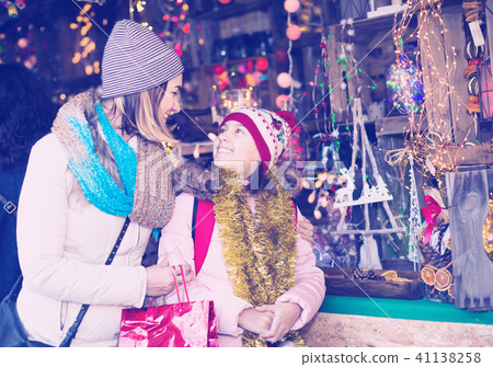 satisfied mother with little daughter buying decorations for Xmas 41138258