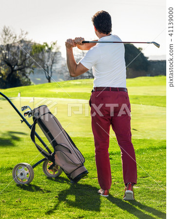 Male golf player made successful hit at golf course Male golf player made successful hit at golf course 41139000