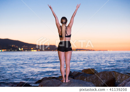 Female 24-31 years old is practicing stretching Female 24-31 years old is practicing stretching 41139208