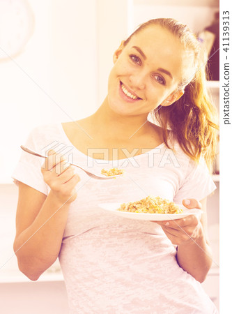 Girl eating porrige Girl eating porrige 41139313