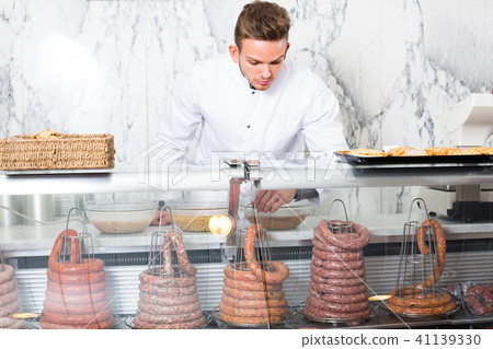 young man cook cutting meat in butcher market 41139330