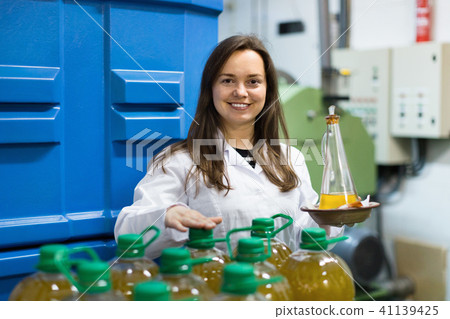 Portrait of female posing with olive oil containers 41139425