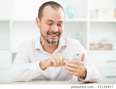 Positive young man with smartphone 41139457