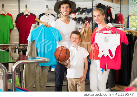 Adult positive parents with boy in sport store Adult positive parents with boy in sport store 41139577