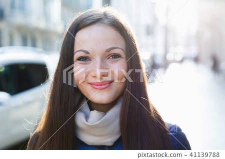 Glad female in the jacket walking at the street Glad female in the jacket walking at the street 41139788