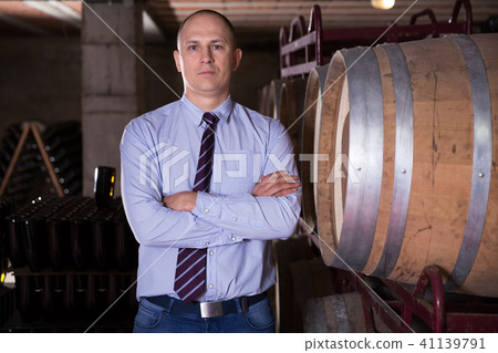 Winemaker standing in wine cellar Winemaker standing in wine cellar 41139791