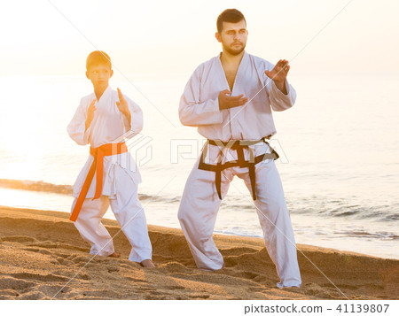 Man and boy exercising karate Man and boy exercising karate 41139807