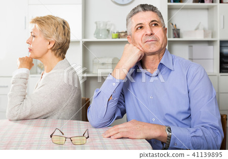 Husband and wife arguing with each other and try to resolve family conflict at table Husband and wife arguing with each other and try to resolve family conflict at table 41139895