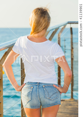 Elegant woman is posing on pirce in her free time Elegant woman is posing on pirce in her free time 41139901