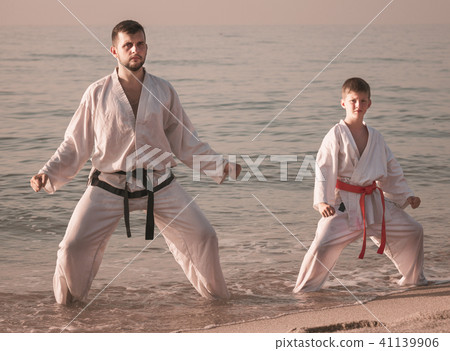 Man and boy exercising karate Man and boy exercising karate 41139906