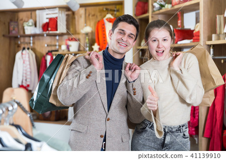 Young woman and man are standing satisfied with packadge after shopping Young woman and man are standing satisfied with packadge after shopping 41139910