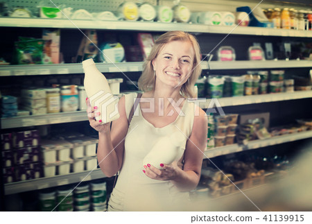 Portrait of adult woman holding bottle with milk Portrait of adult woman holding bottle with milk 41139915