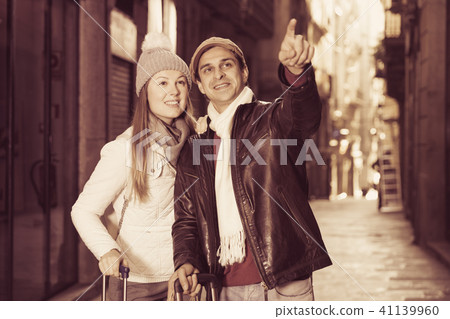 Couple at the historical streets pointing finger Couple at the historical streets pointing finger 41139960