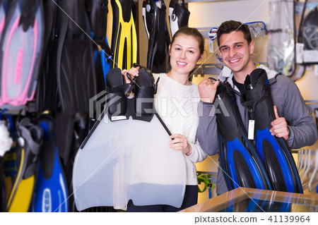 Female and male are standing with flippers Female and male are standing with flippers 41139964