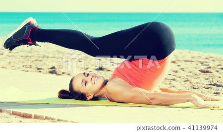 Cheerful young woman training at sea beach Cheerful young woman training at sea beach 41139974