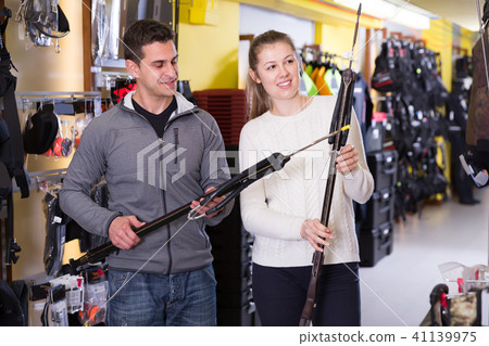 Woman and man are choosing speargun 41139975