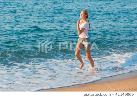 Female in white T-shirt is jogging 41140009
