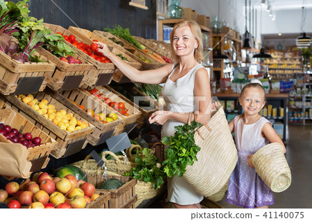 Glad mother with daughter shopping various veggies 41140075