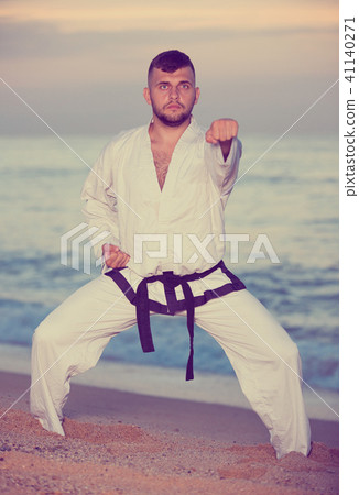 Man doing karate at ocean quay Man doing karate at ocean quay 41140271