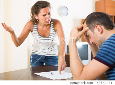 family couple shouting while arguing indoors family couple shouting while arguing indoors 41140274